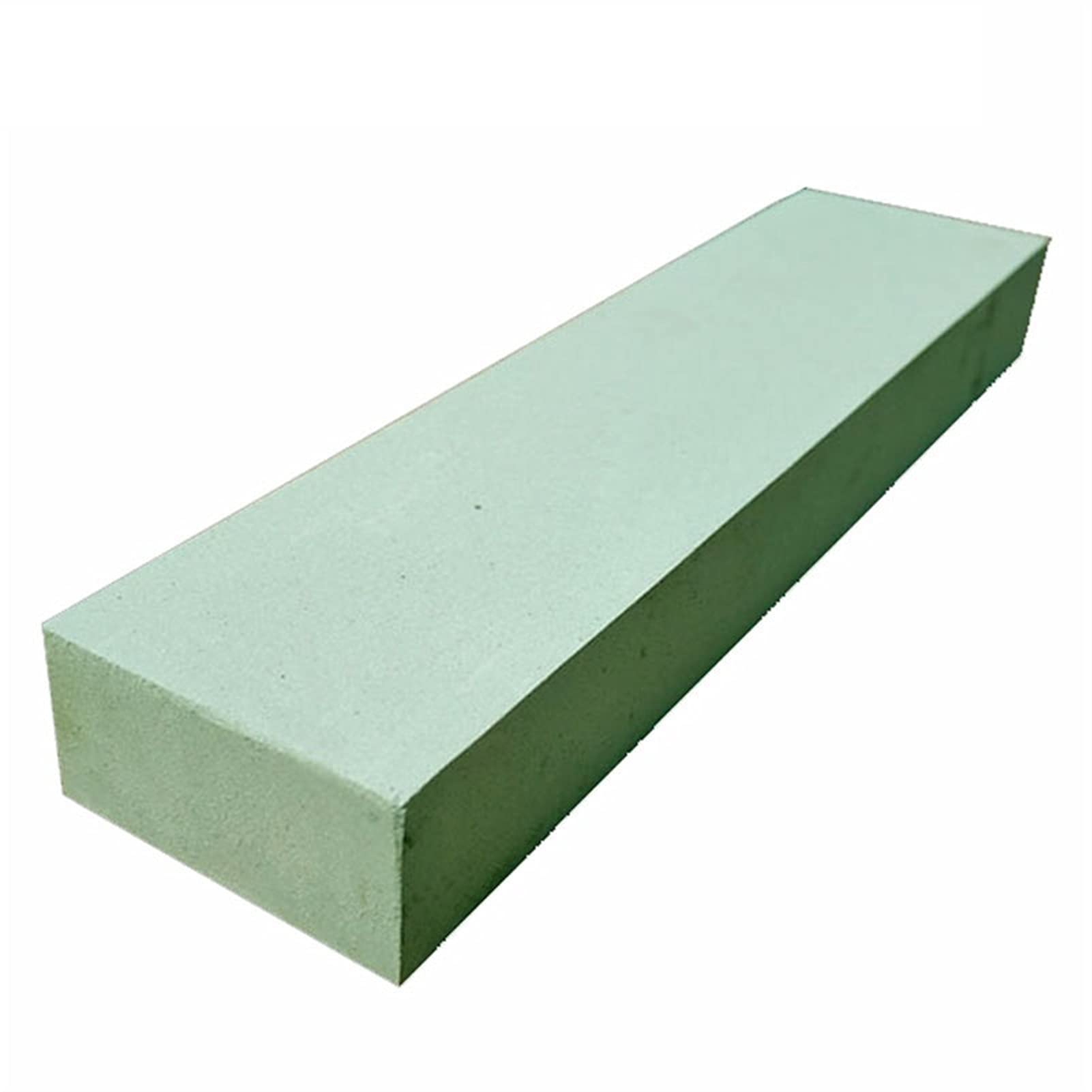 A relevant stock photo of green silicon carbide sharpening stone in a typical setting.