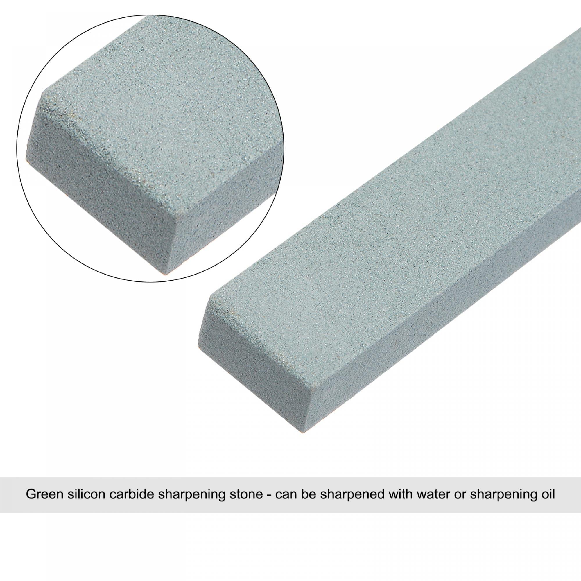 A relevant stock photo of green silicon carbide sharpening stone in a typical setting.
